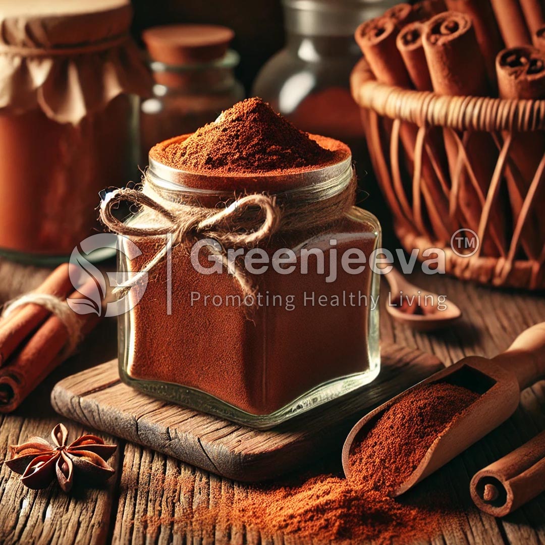 A jar of cassia cinnamon powder powder, tied with twine, surrounded by cinnamon sticks, a wooden scoop, and aromatic star anise.