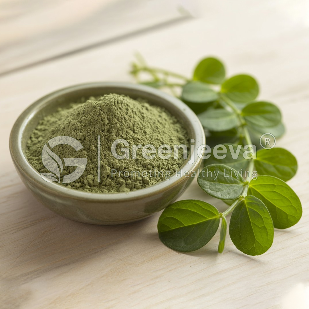 A bowl of green powder beside fresh moringa leaves, set on a wooden surface, promoting healthy living