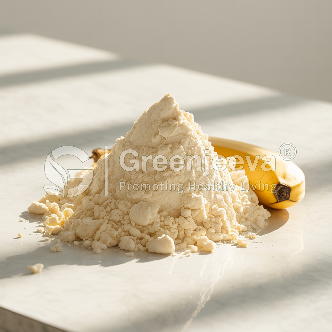 A mound of yellowish powder sits on a marble surface, with a ripe banana nearby, illuminated by soft, natural sunlight.