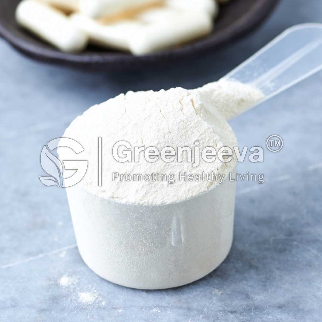Beta Alanine Powder in a clear measuring scoop, with blurred tablets in the background.