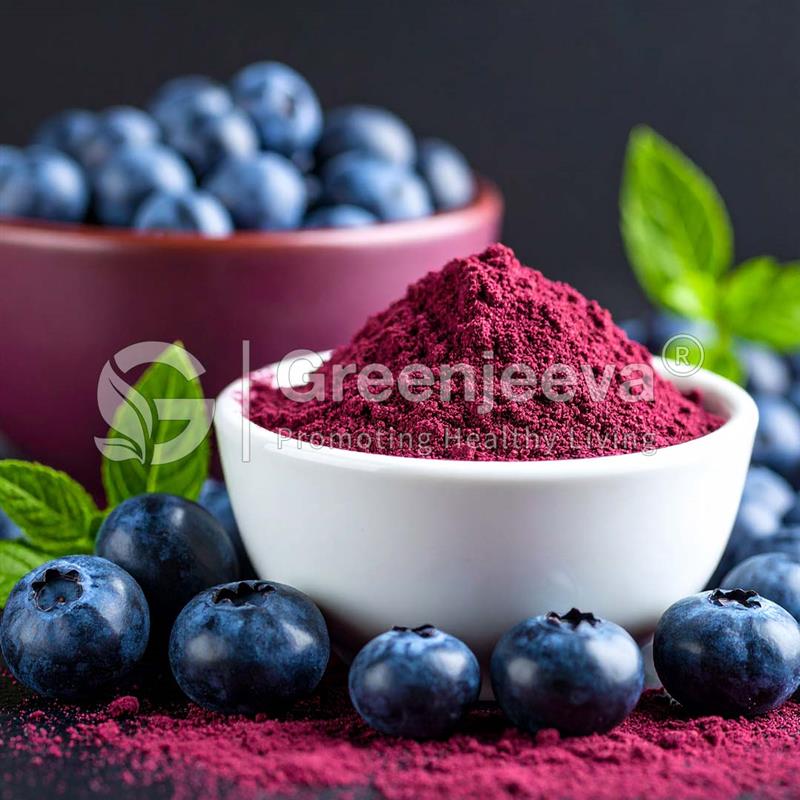 A bowl of vibrant Organic Blueberry Extract Powder 4:1sits in front of fresh blueberries and mint leaves, contrasting with a dark background.