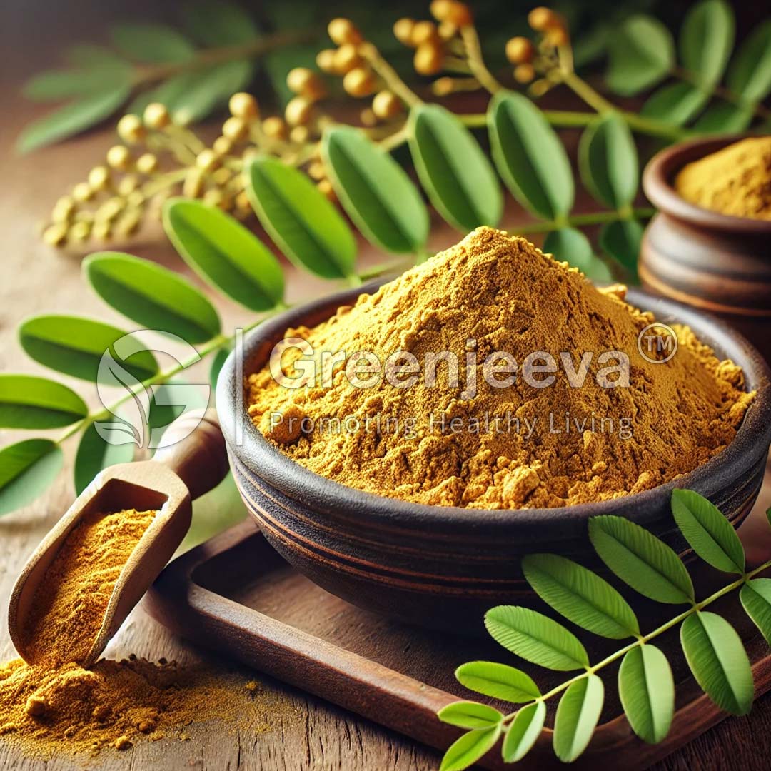 A bowl of Graviola TBC sits surrounded by greenery, with a wooden scoop nearby.
