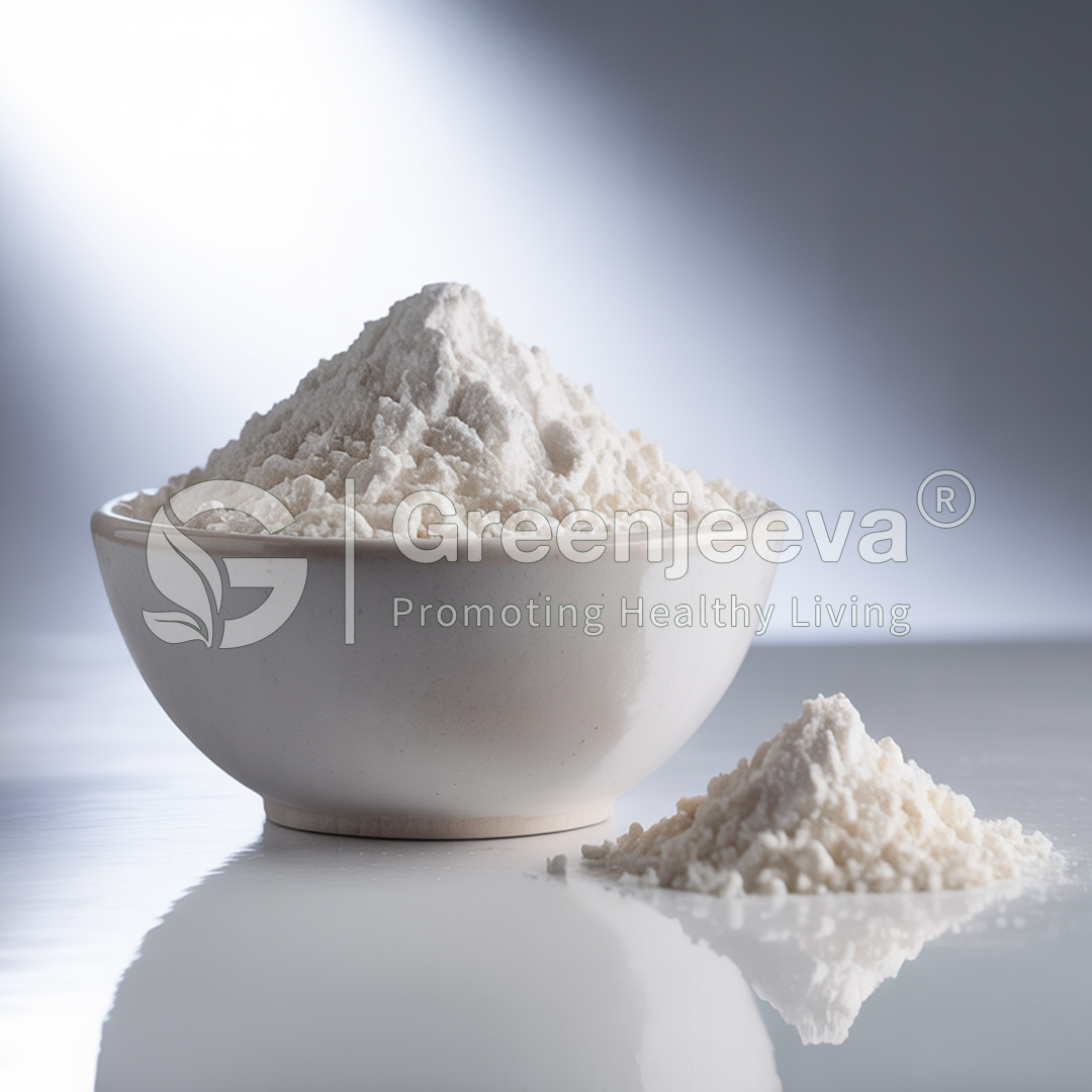 A bowl overflowing with white flour, with a small pile of flour beside it, set against a softly lit backdrop.