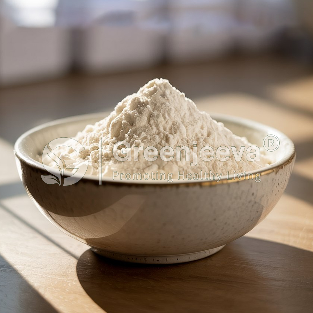 A bowl filled with a mound of fine, white flour, sitting on a wooden surface with soft, natural light illuminating the scene.