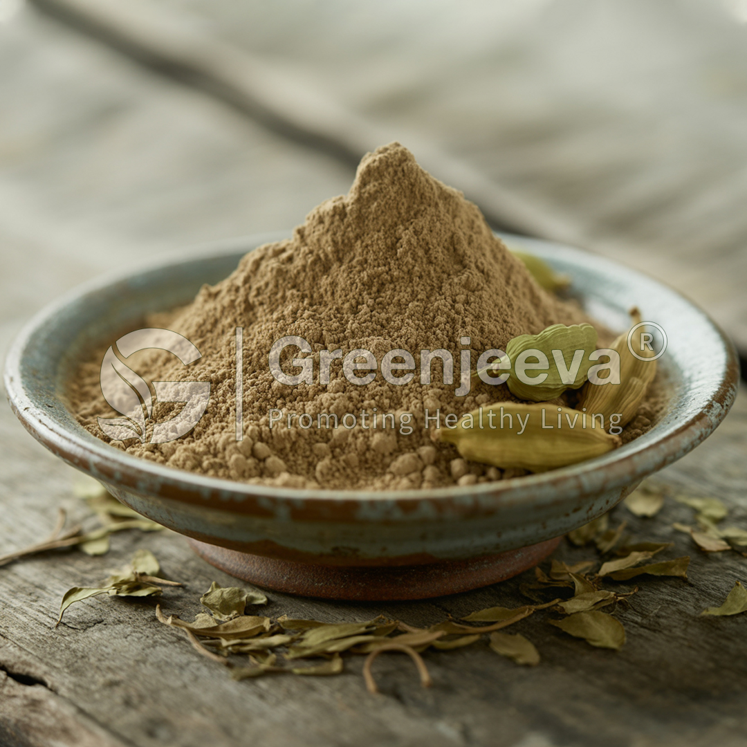 A close-up of a small bowl filled with brown powder, surrounded by dried herbs and cardamom pods on a rustic wooden surface.