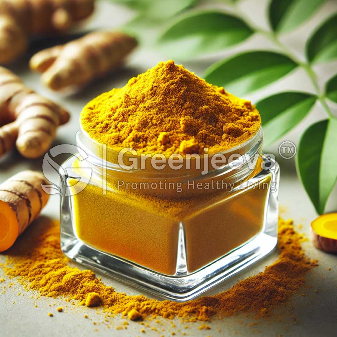 A glass jar filled with vibrant Organic Curcuma longa Extract Powder 4:1 sits on a surface adorned with fresh turmeric roots and green leaves.
