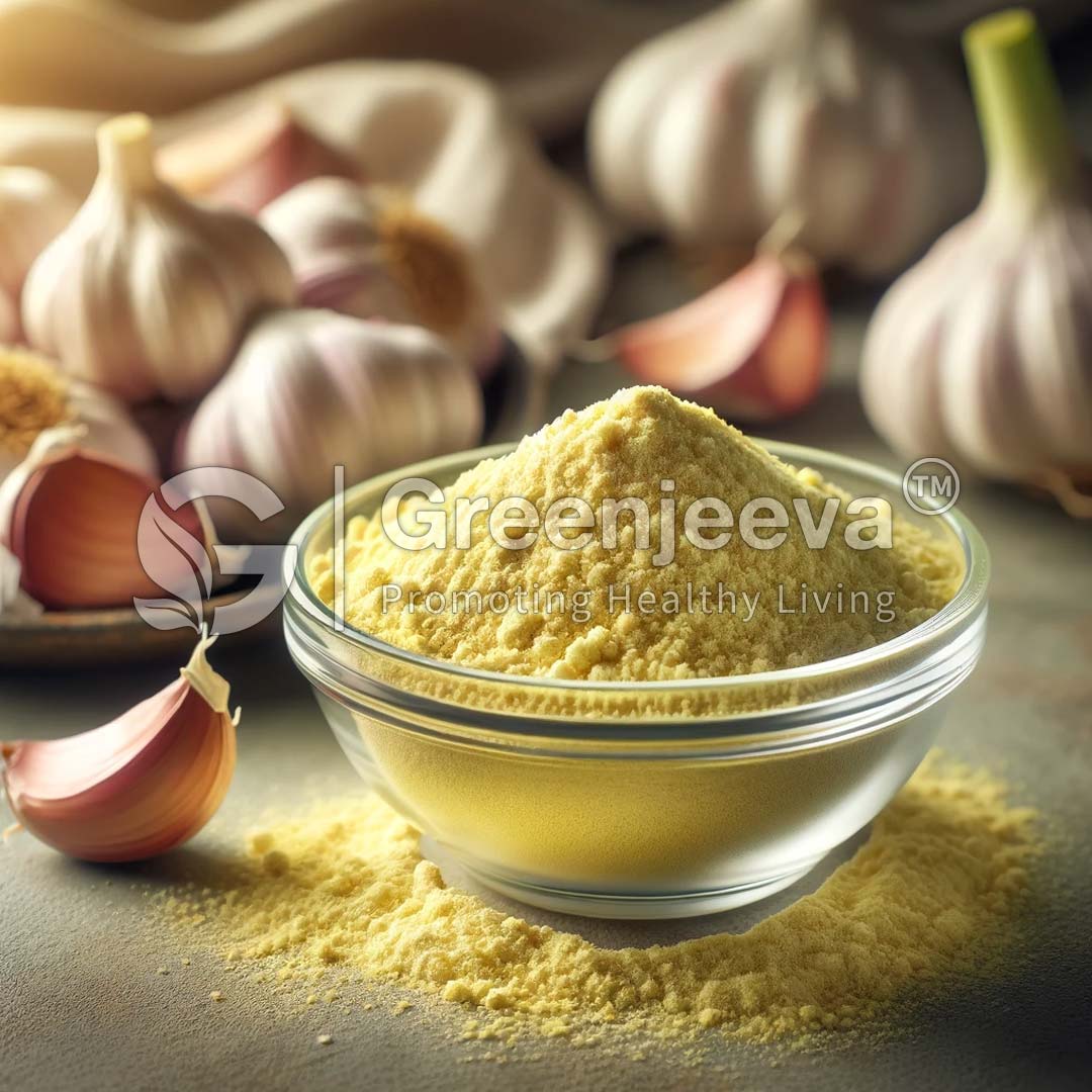 A clear bowl filled with Organic Garlic Powder sits on a countertop, surrounded by whole garlic bulbs and cloves.
