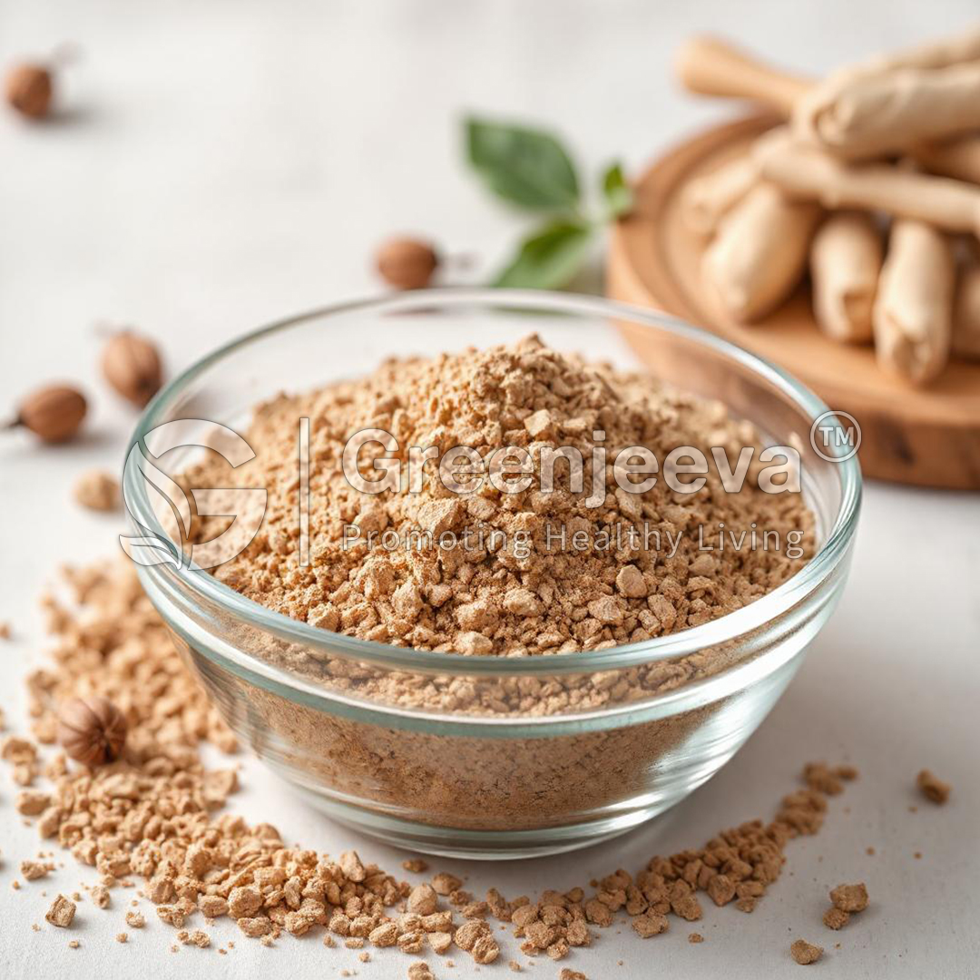 A glass bowl filled with Organic Goats Rue Powder, surrounded by whole nuts and herb leaves, on a light background.