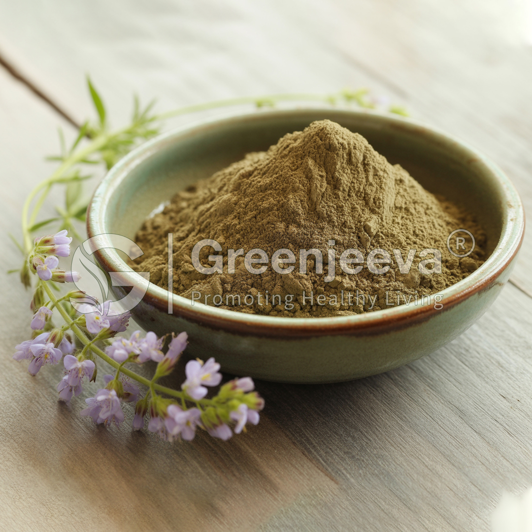 A bowl of green herbal powder sits on a wooden table, surrounded by delicate purple flowers, conveying a sense of natural health.