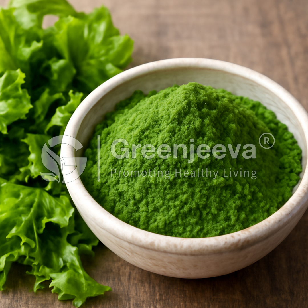 A bowl of vibrant green powder sits alongside fresh lettuce leaves, symbolizing health and nutrition.