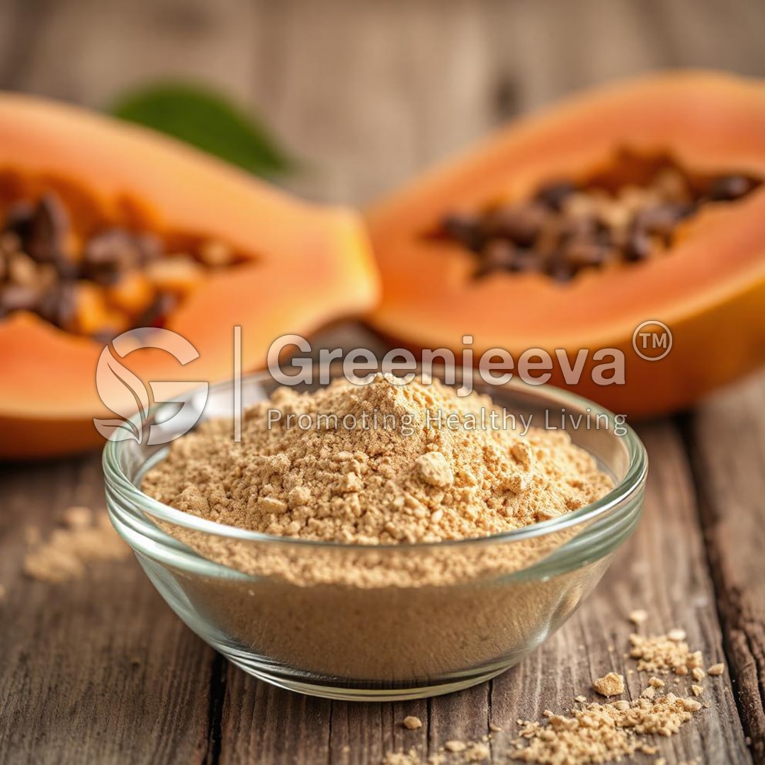 A glass bowl filled with brown papaya powder, with halved papaya in the background showcasing seeds on a wooden surface.