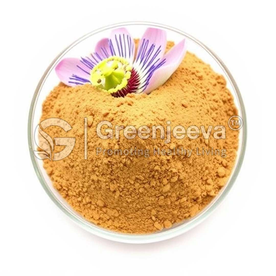 A glass bowl filled with fine, golden-brown powder topped with a vibrant purple and green flower, symbolizing health and wellness.