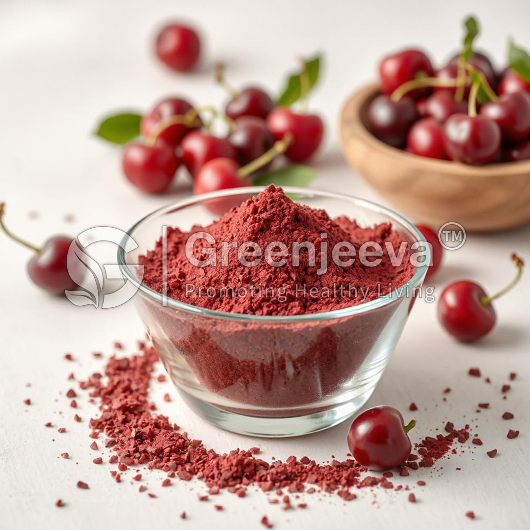 A glass bowl filled with Organic Tart Cherry Extract Powder, surrounded by fresh cherries.