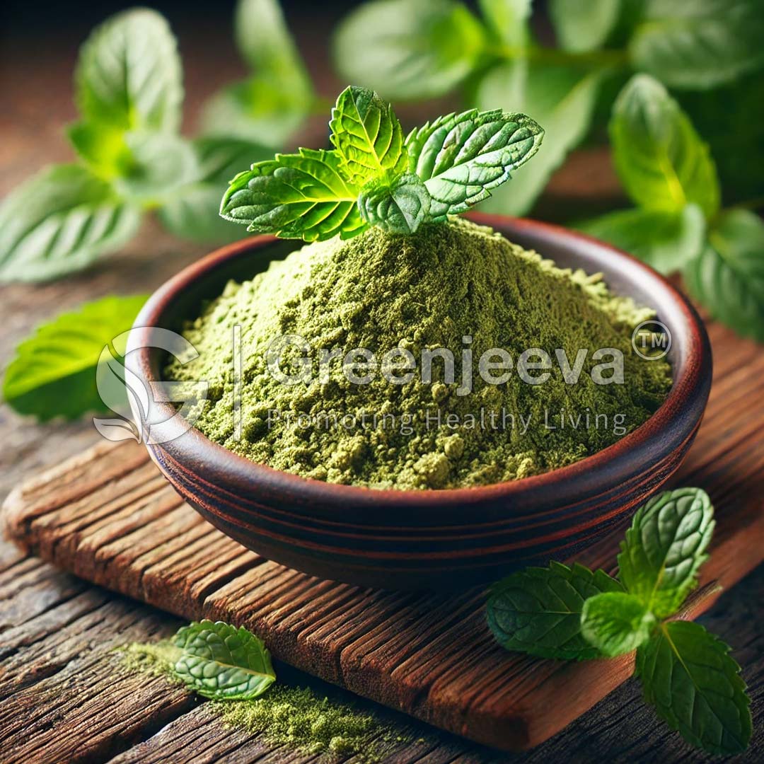A wooden bowl filled with green peppermint powder, topped with fresh peppermint leaves, surrounded by scattered mint leaves on a rustic wooden surface.