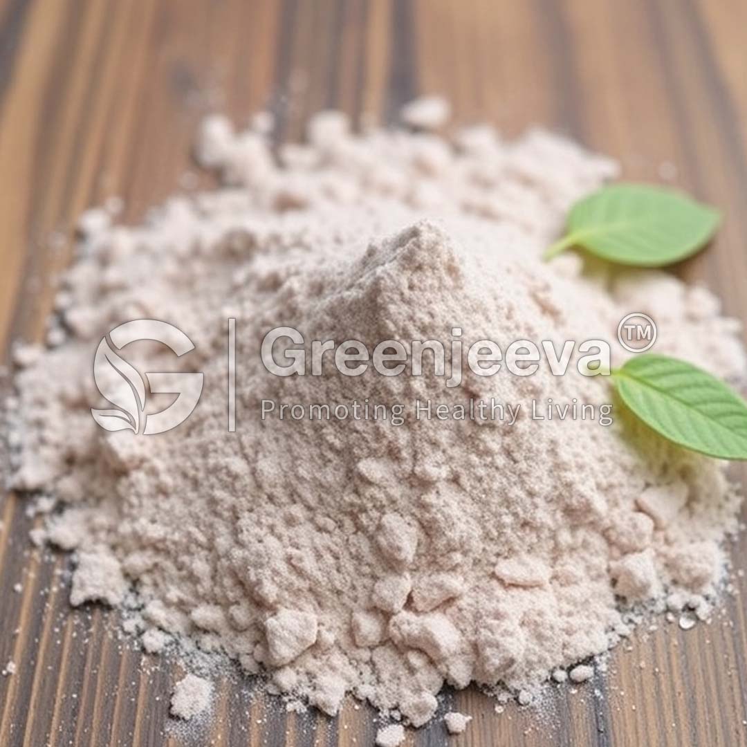 A mound of light pink powder sits on a wooden surface, accompanied by fresh green leaves, representing health and wellness.